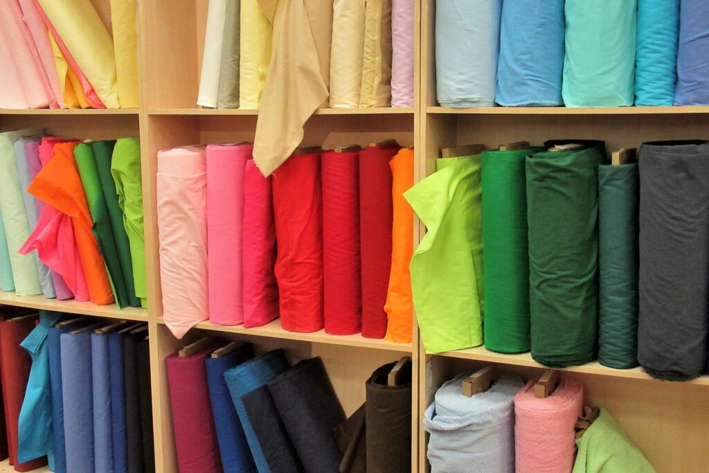 Lifestyle, " Bolts of Colored Cloth on a Shelf "