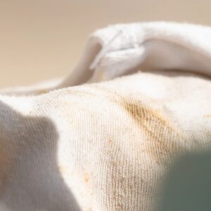 Abstract background of old rolled dirty fabric with beige and brown tones.